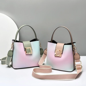 Minimalist gradient bucket bag with pastel hues and striped shoulder strap in studio setting