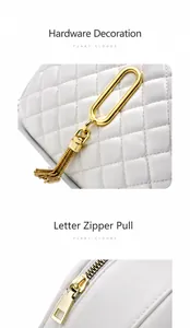 Detail of white quilted leather bag featuring gold tassel charm and metallic zipper