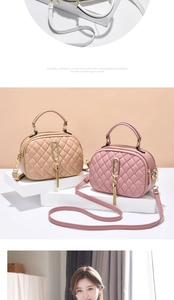 Detail of quilted leather crossbody bag with metal ring and long tassel in beige and pink
