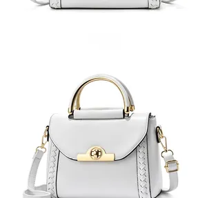 Detail of white PU leather handbag featuring golden rotary lock and woven side texture