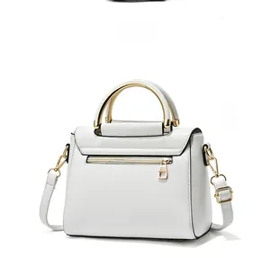 Side view of white faux leather handbag featuring a gold metal handle and zip pocket