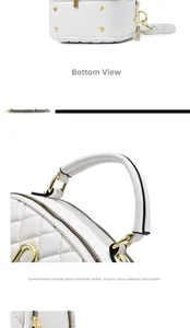 Close-up of white quilted handbag featuring gold protective base studs and rounded handle