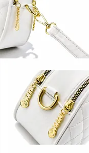 Detail of white quilted leather bag with high-quality gold hardware and logo zippers