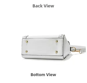 Detailed bottom view of white minimalist handbag showing four golden metal protective studs