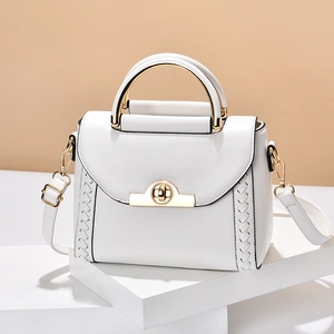 White minimalist leather handbag with woven edges and semi-circular gold metal handle