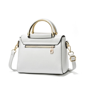 Minimalist white leather handbag with golden metal top handle and adjustable shoulder strap