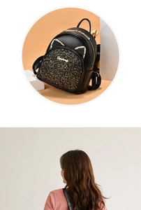 Detail of black mini sequin backpack with golden cat ear accents and glittery pocket