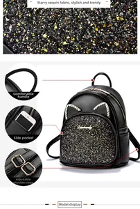 Macro shot of sparkling sequins, cat ear rhinestone details and metal zipper on black bag