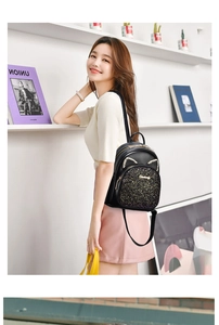 Detail view of black sequin mini backpack featuring sparkling glitter and cat ears with rhinestones