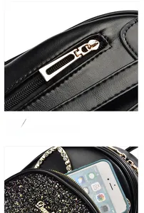 Detail of black sequined backpack with gold hardware and rhinestone chain accents