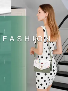 Detail of a chic shoulder bag featuring Eiffel Tower illustration and gold cat pearl tassel