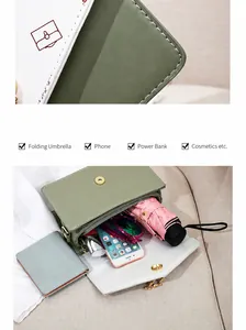 Interior view of small crossbody bag showing capacity for phone, umbrella and power bank
