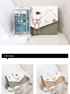 Detail of color-blocked crossbody bag with French travel prints and pearl charm