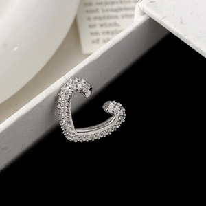 Silver heart-shaped ear cuff featuring pavé cubic zirconia set on a luxury gift box