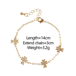 Macro view of gold cross bracelet with micro-pave cubic zirconia and lobster clasp