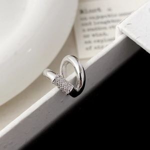 Macro shot of silver minimalist ear cuff with shimmering micro-pave zirconia details