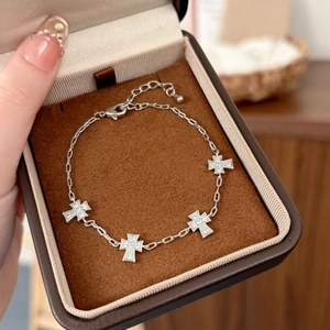 Elegant silver cross bracelet with four sparkling micro-inlaid zircon cross pendants