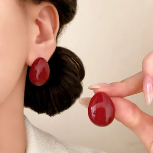 Minimalist deep red oval stud earrings with a glossy finish for a modern luxury look