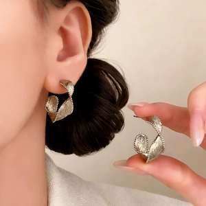 Minimalist vintage spiral twist gold stud earrings with textured brushed metal finish