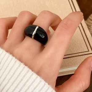 Retro black enamel dome ring with silver metal stripe shown worn on a female hand