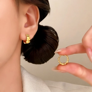 Minimalist gold plated textured hoop earrings for women showing model wear and hand detail