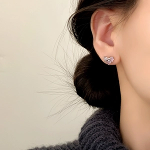 Elegant bow and pink heart zircon earrings on model, stylish silver jewelry for women