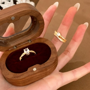 Elegant 18K gold-plated zircon rings displayed on a premium walnut wood jewelry gift box