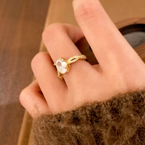 Gold-plated ring with large oval zircon and twisted diamond-encrusted band for women
