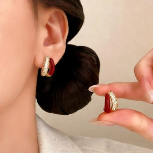 Elegant gold earrings with micro-inlaid zircon and deep red oil drop resin finish