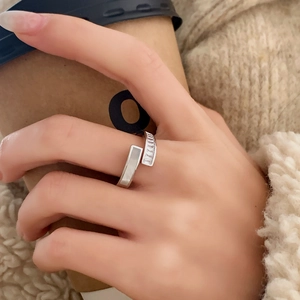 Elegant silver open ring with shell inlay and pavé zircon on model holding a coffee cup