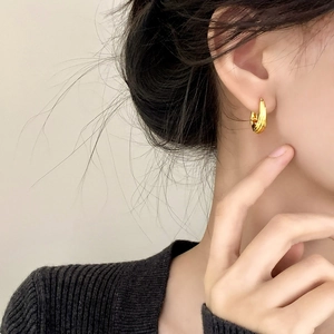 Elegant gold plated twisted hoop earrings for women with textured spiral design