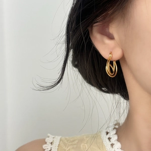 Minimalist double layer gold hoop earrings worn by a model for a refined look