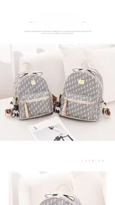 Close-up of stylish monogram backpack with bow detail and cute bear keychain charm
