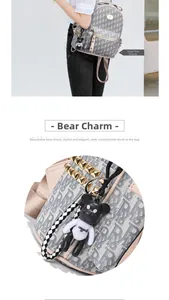 Detail of grey monogram backpack with gold studs and cute 3D bear keychain accessory