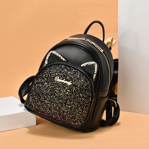 Chic black mini backpack with cat ears and glitter sequins on orange background