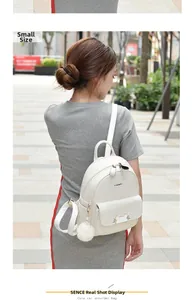 Detail of small white PU leather backpack featuring cat ears and diamond quilted pattern