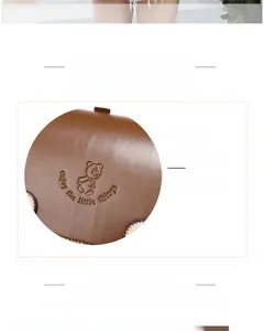 Detail of caramel leather backpack featuring cute bear embossing and smooth lychee texture