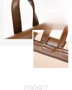 Close-up of brown leather top handle and reinforced shoulder strap stitching details