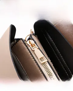 Detailed close-up of polished gold-tone hardware and smooth adjustable buckle on the backpack
