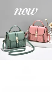 Detail of dark green and pink handbags with V-shaped embossing and gold metal locks