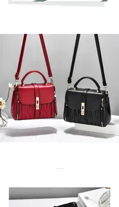 Detail of red and black crossbody bags with gold metal locks and V-quilted stitching