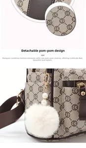 Detailed macro view of monogram fabric texture and decorative fur ball pearl pendant