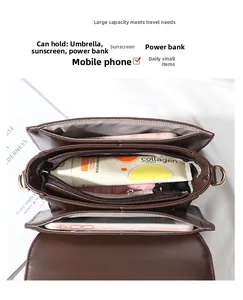 Detail view showing multi-layer interior compartments and storage space of the crossbody bag