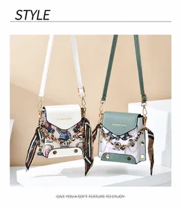 Detail of mini crossbody bags with silk scarf decor and gold chain link accents