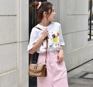 Retro flap crossbody bag with logo print pattern and metallic clasp detail on model