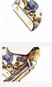 Detailed close-up of mini crossbody bag with cartoon bear print and silk scarf handle