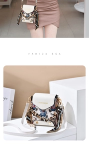 Detailed view of mini white crossbody bag with cartoon bear print and silk scarf decor