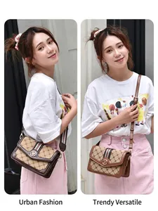 Brown monogram crossbody bag with green-red ribbon and adjustable strap in outdoor street view