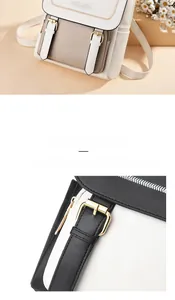 Close-up of gold metal buckle and embossed floral detail on two-tone leather backpack