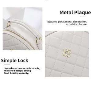Detail of white quilted handbag showing golden hardware and reinforced handle